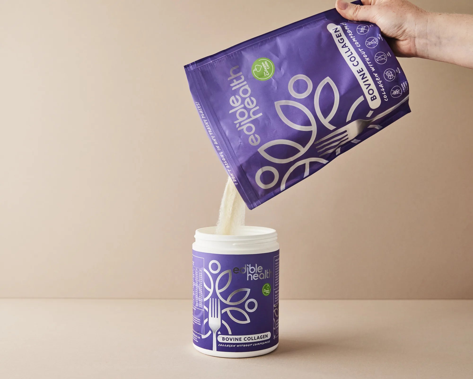 Collagen powder poured from a refill pouch into a tub